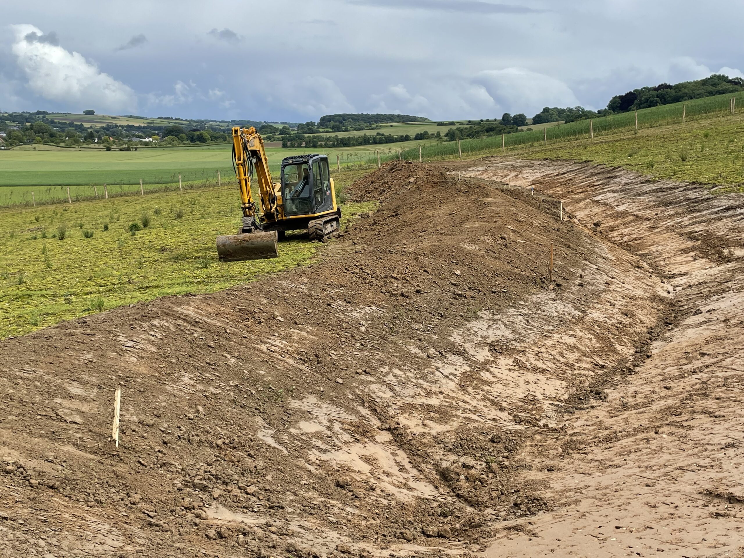 digging a swale to prevent runoff to mitigate floods and drought